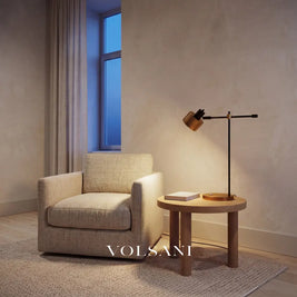 Adjustable iron lamp with rotating head lit in a Japandi reading nook at dusk