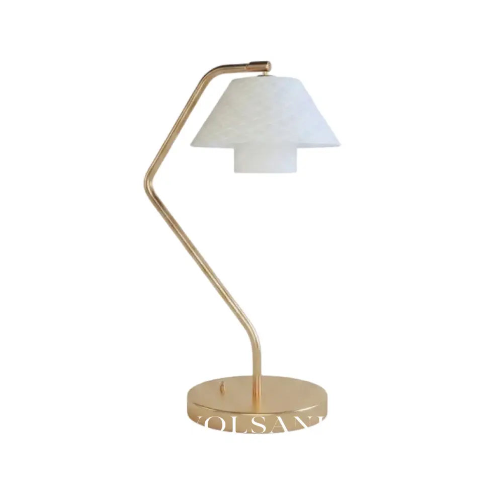 Ceramic table lamp with copper frame and quilted shade on a white background