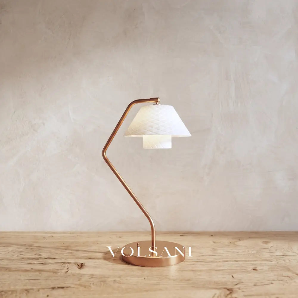 Close-up of the ceramic lamp with copper frame and quilted shade on raw oak