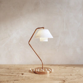 Close-up of the ceramic lamp with copper frame and quilted shade on raw oak