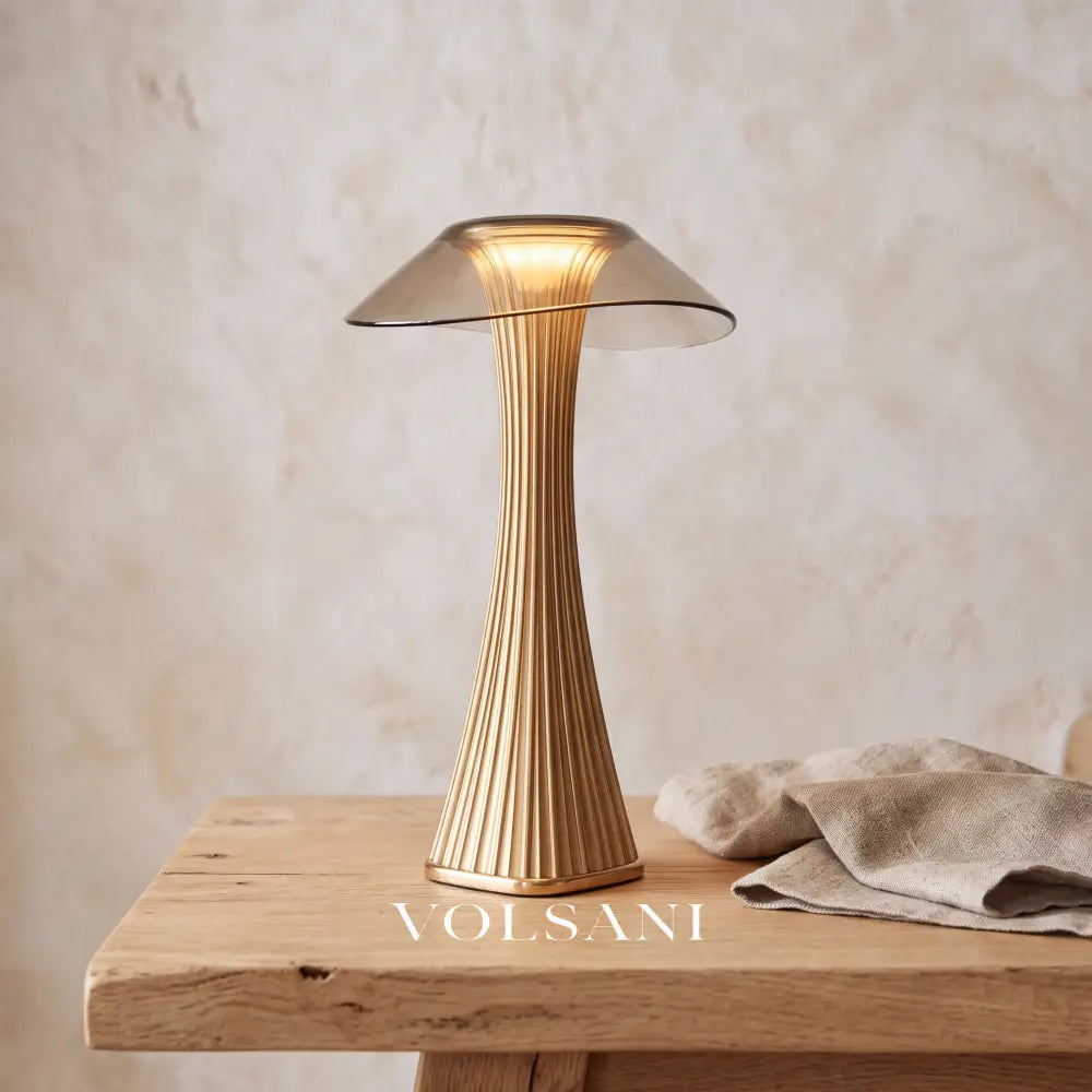 Close-up of the bronze mushroom table lamp on raw oak against a plaster wall