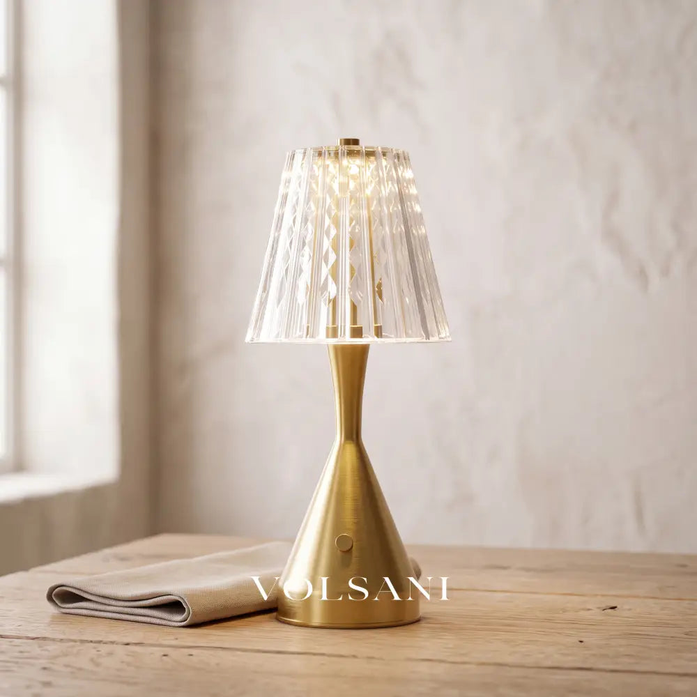 Close-up of the crystal-look acrylic nightstand lamp on raw oak against a plaster wall