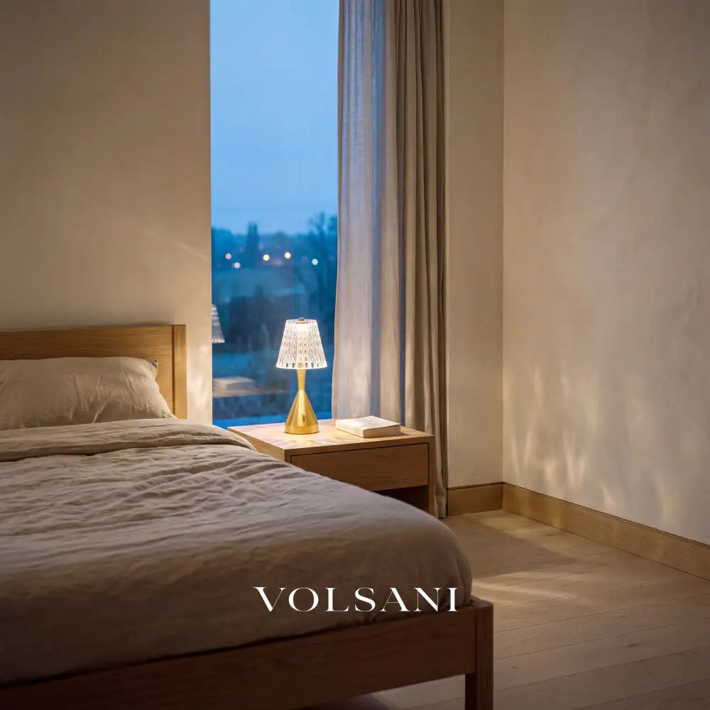 Crystal-look acrylic nightstand lamp lit on a bedside table in a Japandi bedroom at dusk