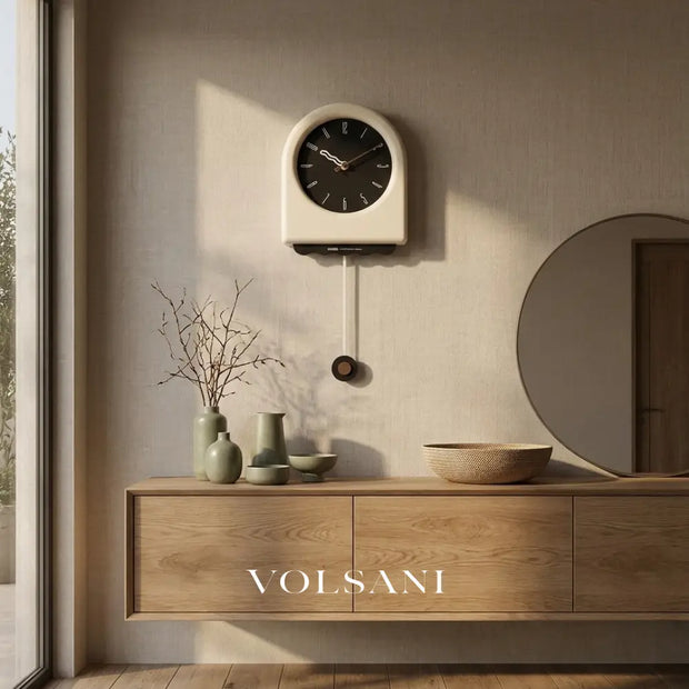 JOOST cream pendulum wall clock above a console table