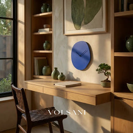 EERO minimalist wall clock in blue above a desk in a home office