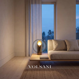 Postmodern glass lamp lit beside a linen sofa in a Japandi living room at dusk