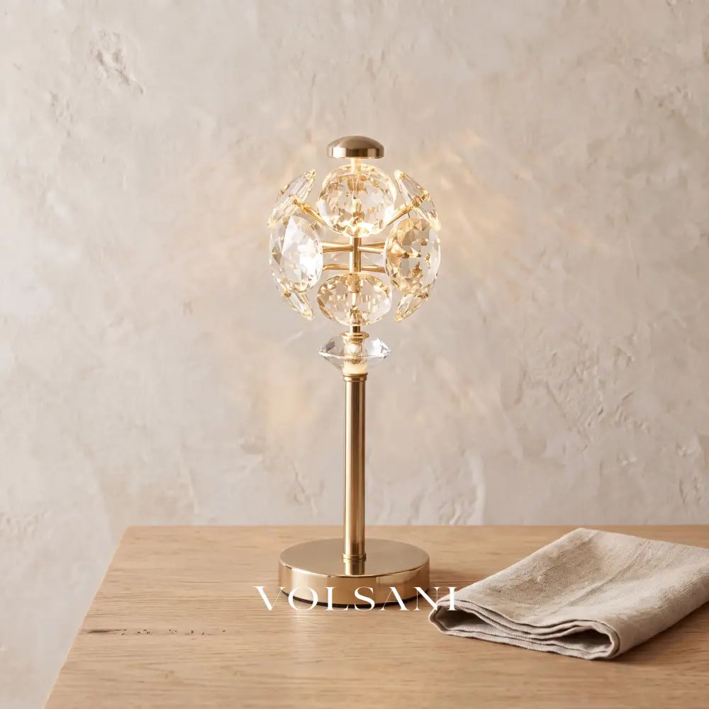 Close-up of the crystal panel globe lamp on raw oak against a plaster wall
