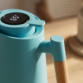 Macro detail of the thermal jug temperature display and wooden handle