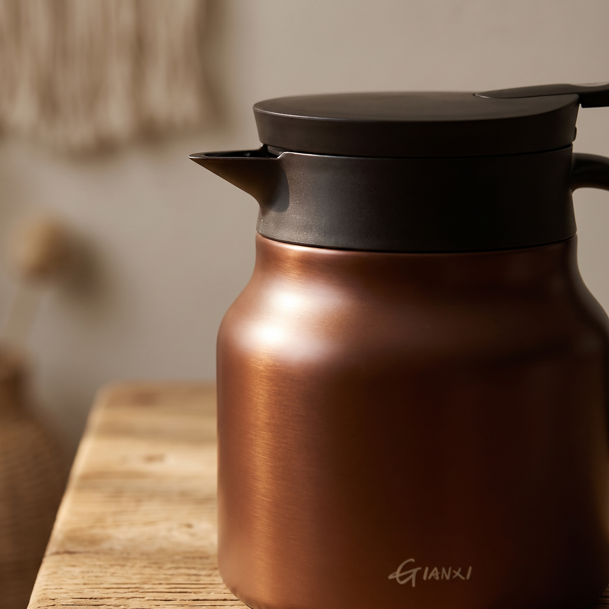 Macro detail of the insulated teapot spout and lid seam