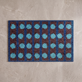 Mechanical Rainbow Bauhaus bath mat, overhead on stone floor