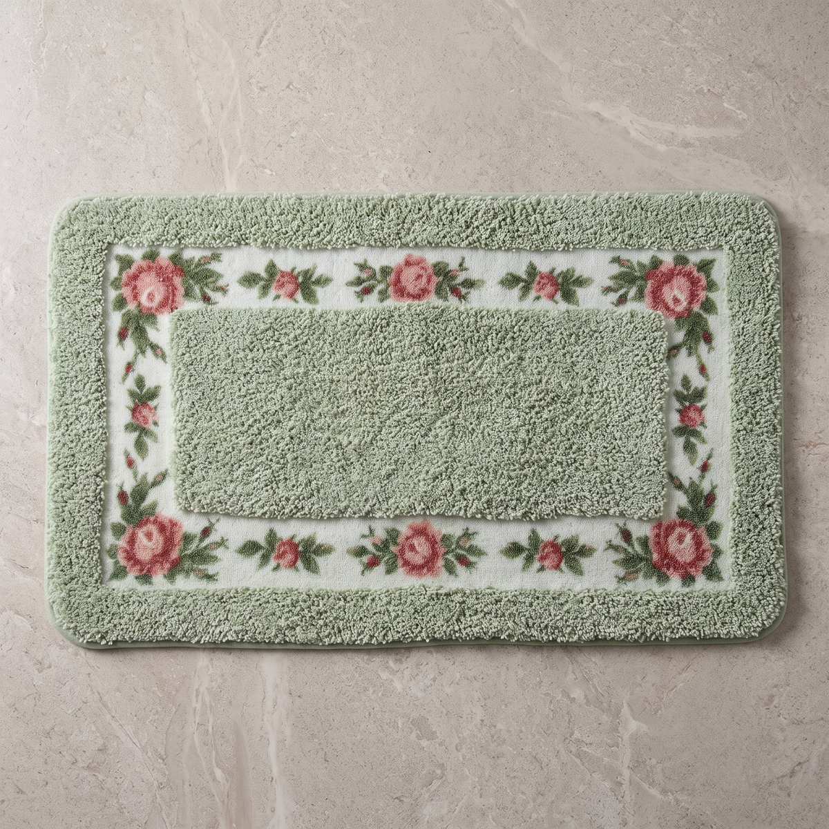 Sage Charm floral border bath mat, overhead on stone floor