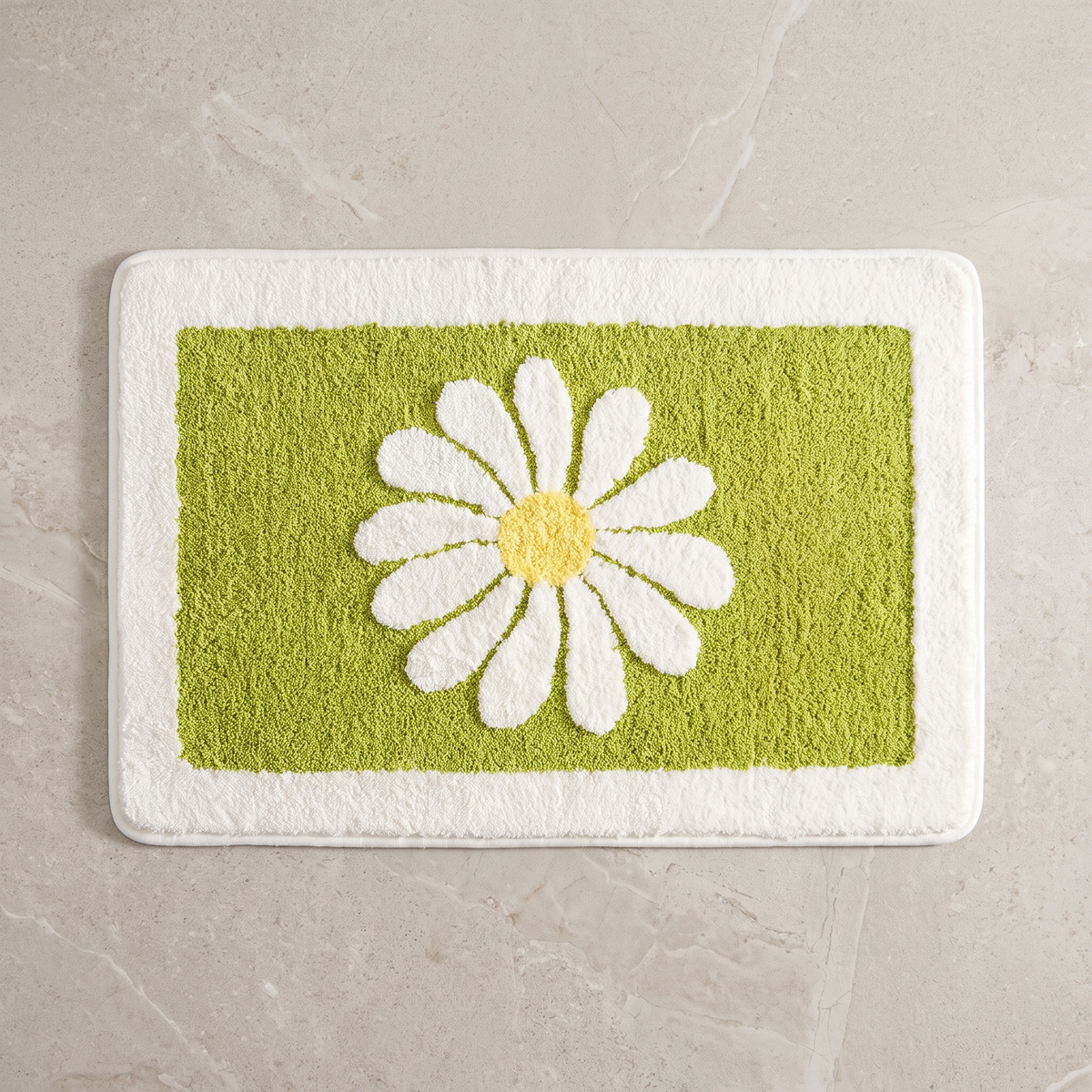 Mint Bloom daisy bath mat, overhead on stone floor