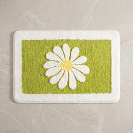 Mint Bloom daisy bath mat, overhead on stone floor