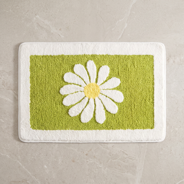 Mint Bloom daisy bath mat, overhead on stone floor