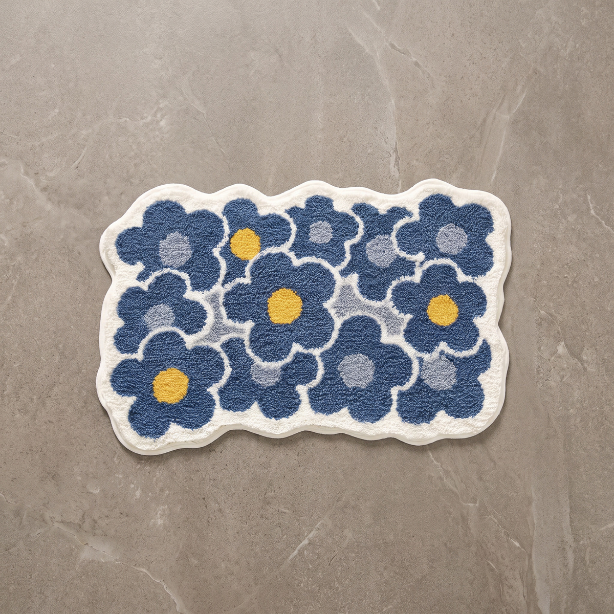 Cool Garden tufted floral bath mat, overhead on stone floor