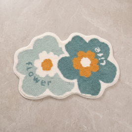 Whimsical Flower tufted floral bath mat, overhead on stone floor
