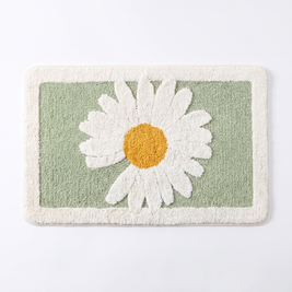 Daisy plush bath mat on a white background, overhead