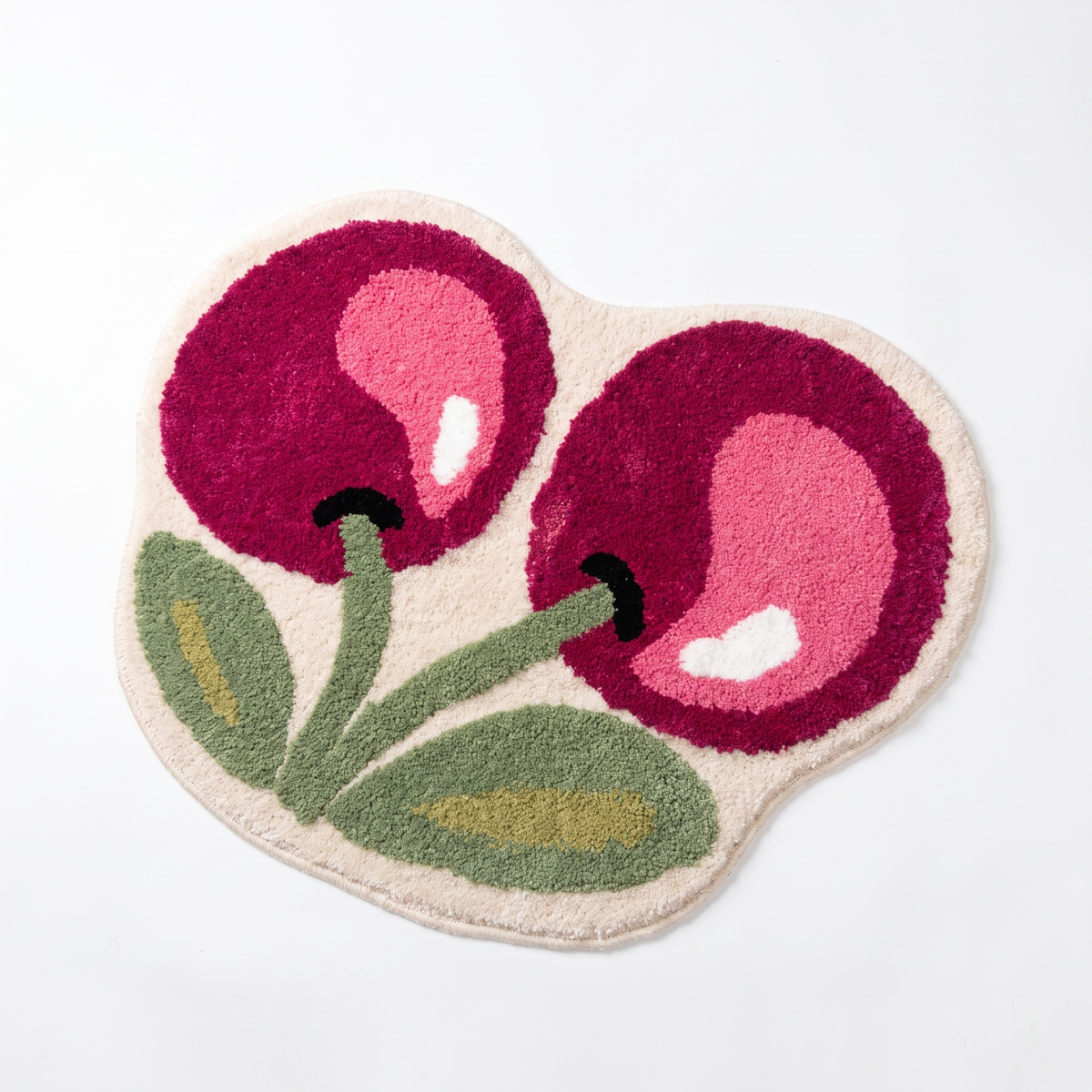 Cherry bath mat on a white background, overhead