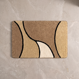 Sand Dune plush wave bath rug on a pale stone floor, overhead