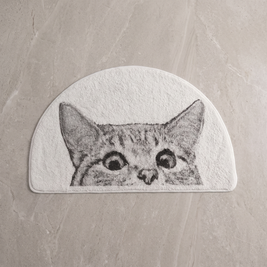 Sneaky Kitty cat bath mat on a pale stone floor, overhead