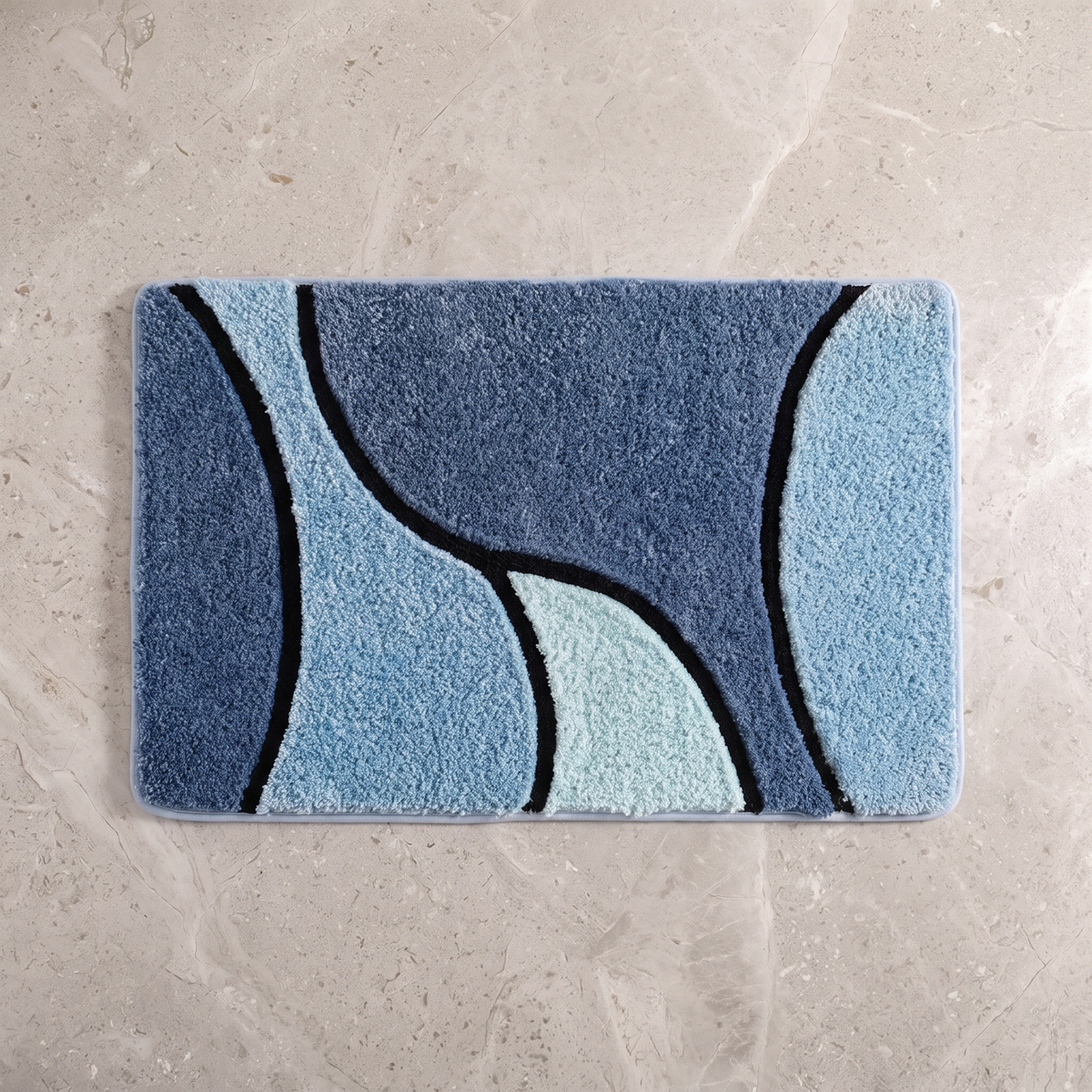 Ocean Mist plush wave bath rug on a pale stone floor, overhead