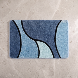 Ocean Mist plush wave bath rug on a pale stone floor, overhead
