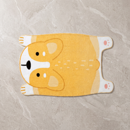 Yellow animal motif floor mat on a pale stone floor, overhead