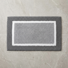 Black striped microfiber bath mat on stone floor, overhead