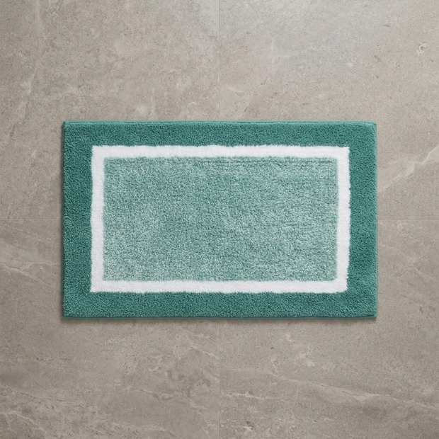 Blue striped microfiber bath mat on stone floor, overhead