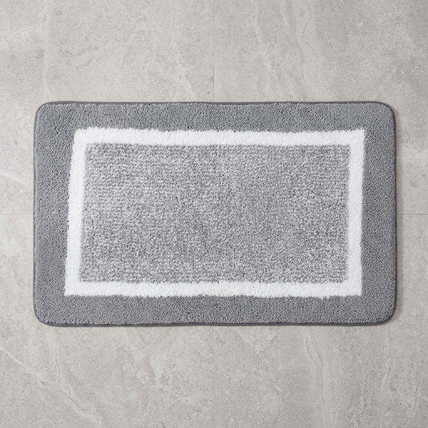 Beige striped microfiber bath mat on stone floor, overhead
