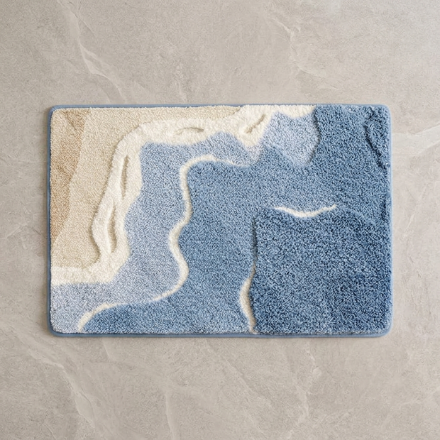 Coastal Drift terrain plush bath rug on stone floor, overhead