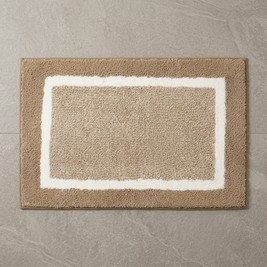 Red striped microfiber bath mat on stone floor, overhead
