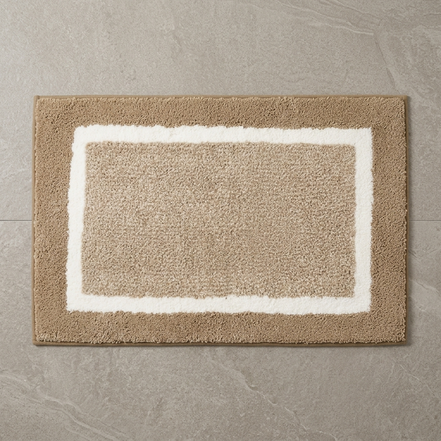 Red striped microfiber bath mat on stone floor, overhead