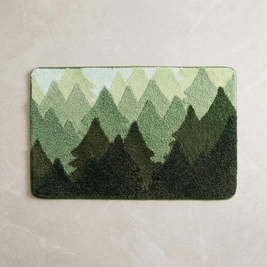 Forest Retreat terrain plush bath rug on stone floor, overhead