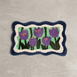 Blue colorful floral bath mat on stone floor, overhead
