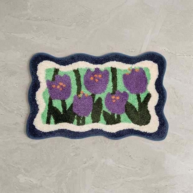 Blue colorful floral bath mat on stone floor, overhead