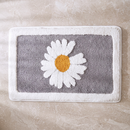 Ash Flower plush bath mat on stone floor, overhead