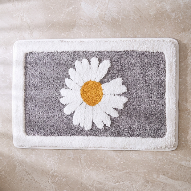 Ash Flower plush bath mat on stone floor, overhead