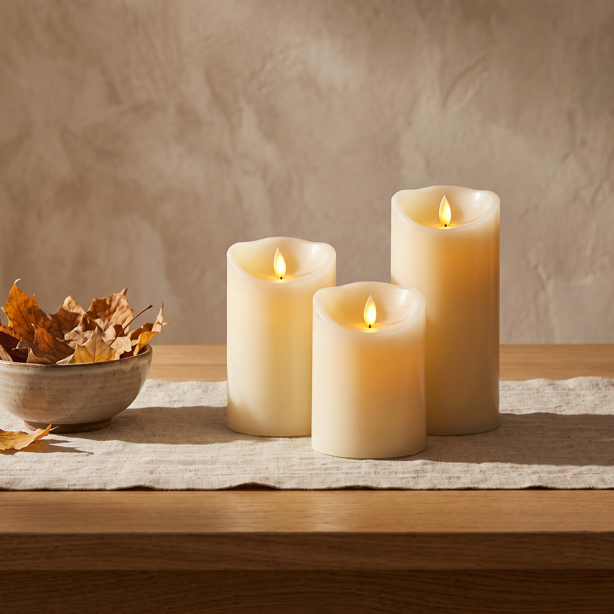 Rechargeable flameless pillar candles on an oak dining table