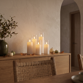 White flameless candles on a dining room sideboard