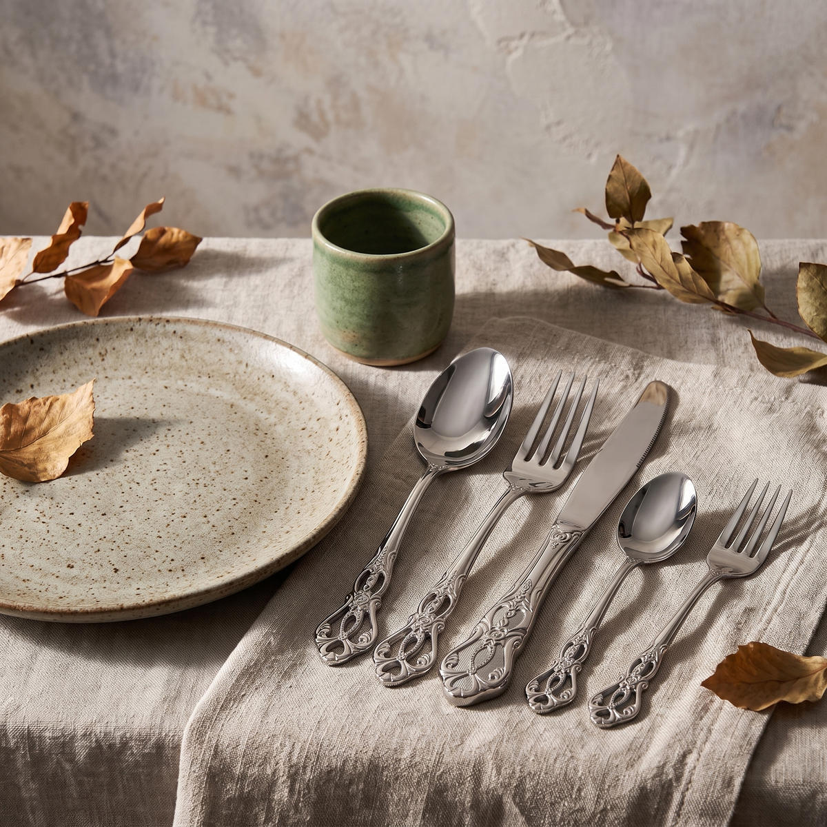 Baroque flatware place setting on a linen napkin