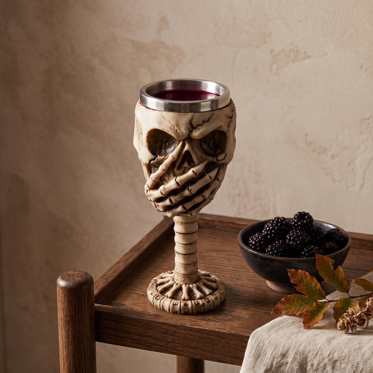 Skull goblet with covered mouth on an oak bar cart