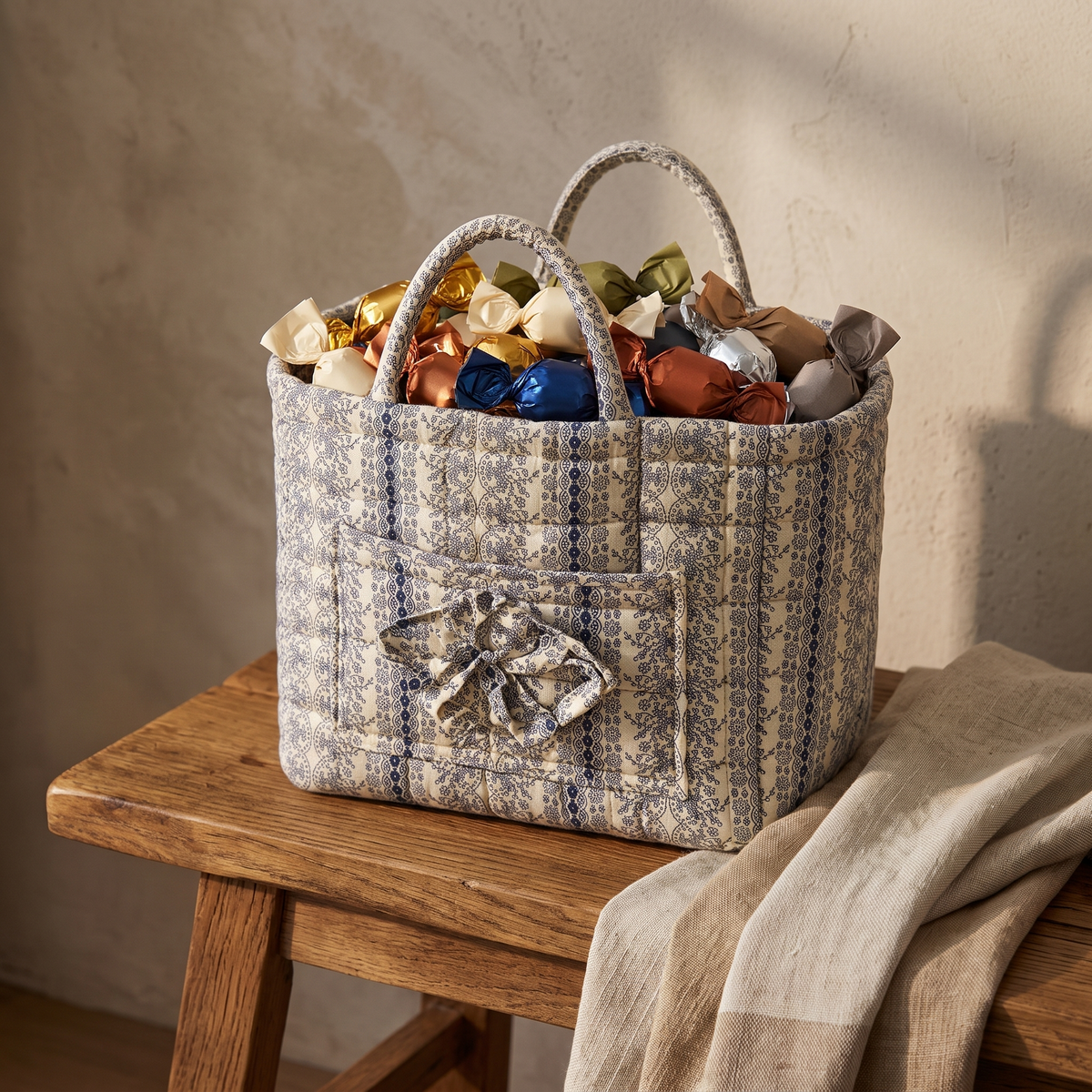 Blue stripe floral quilted basket filled with wrapped candy