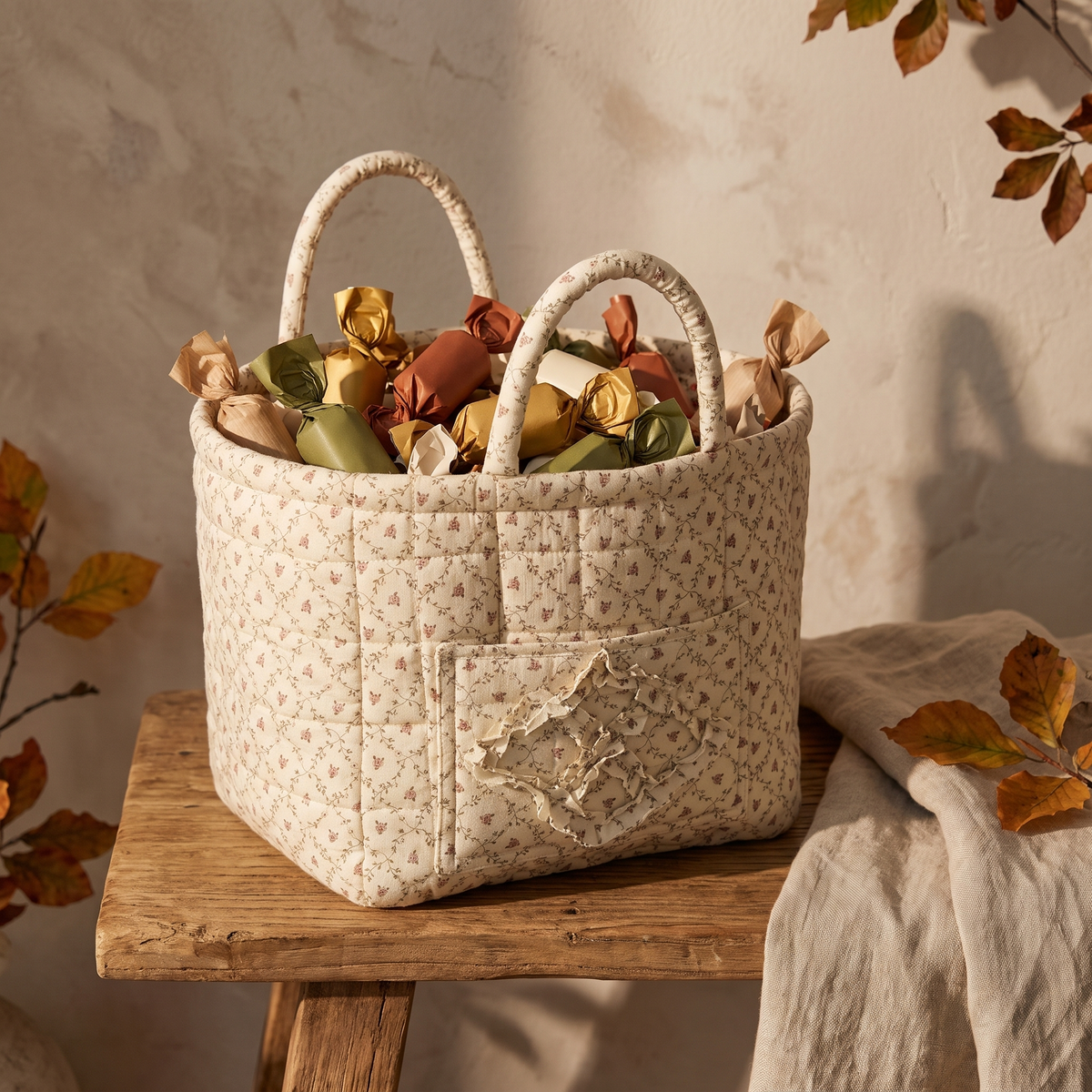 Cream floral quilted basket filled with wrapped candy