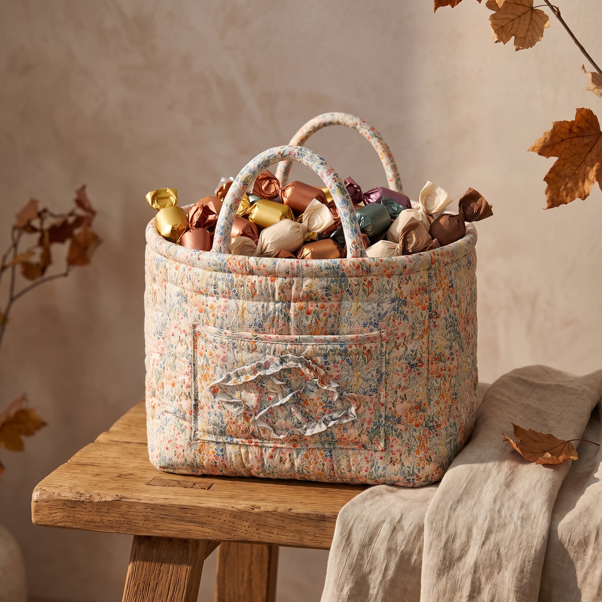 Peach floral quilted basket filled with wrapped candy