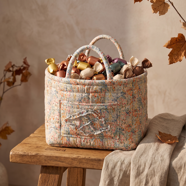 Peach floral quilted basket filled with wrapped candy