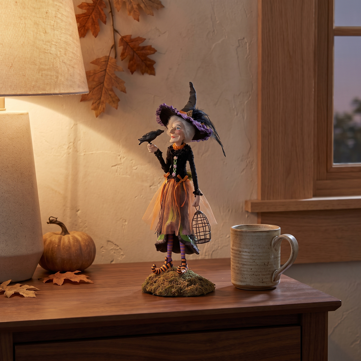 Witch figurine on a walnut bedside table in lamp light