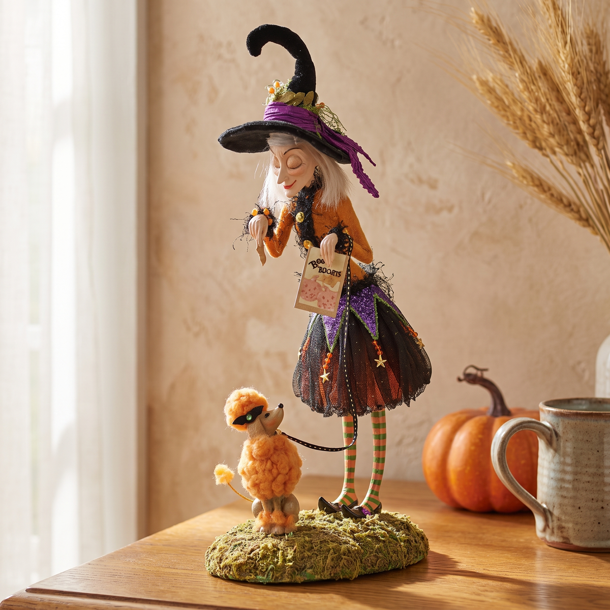 Belinda witch figurine close-up on an oak sideboard
