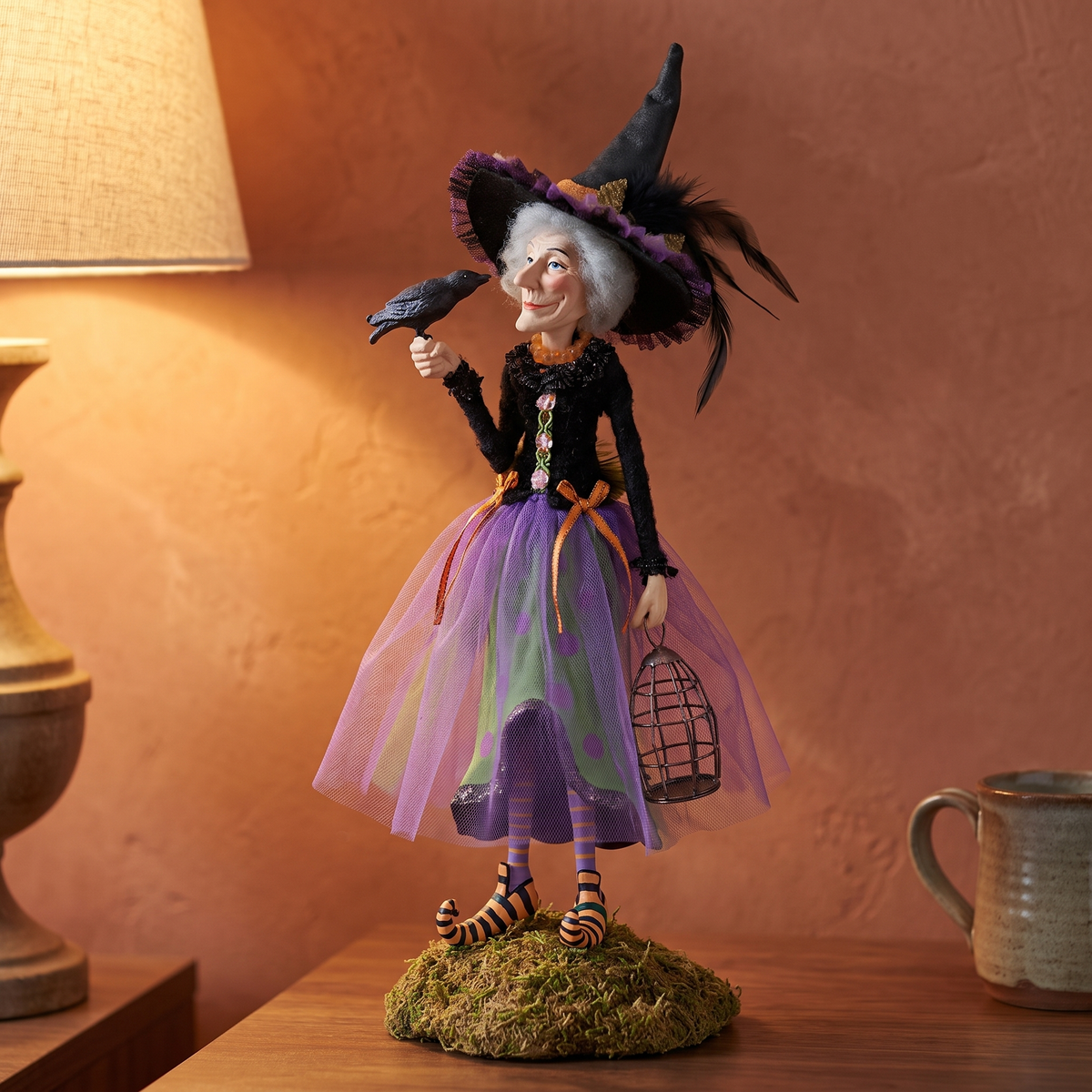 Esther witch figurine close-up on a walnut bedside table