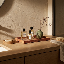 Red marble tray with perfume bottles on a Japandi bathroom vanity